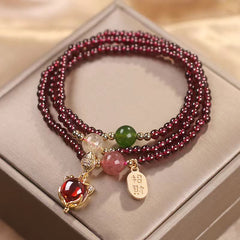 Triple-strand garnet wrap bracelet with fox charm red gemstone center and zhao cai attract wealth gold tag charm with mixed jade citrine and quartz accent beads on satin box