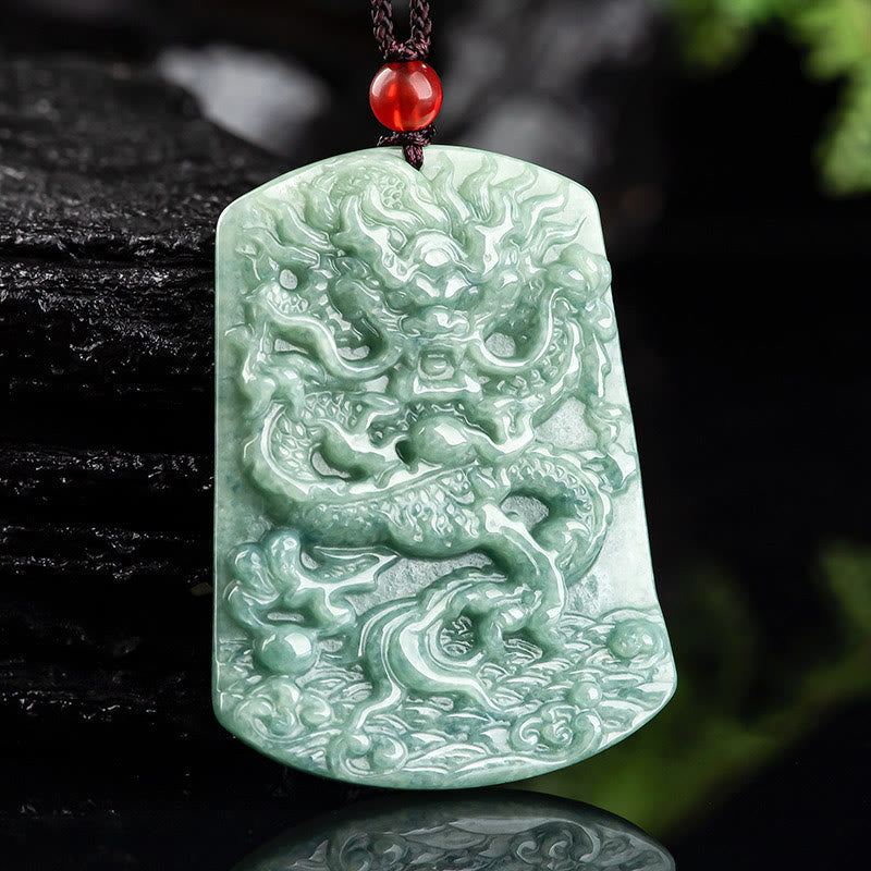 Natural Jade Dragon Pendant – Celadon jade dragon pendant held in hand against natural backdrop, Handcrafted detail
