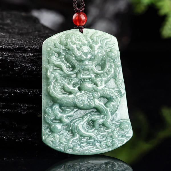 Natural Jade Dragon Pendant – Celadon jade dragon pendant held in hand against natural backdrop, Handcrafted detail
