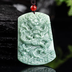 Natural Jade Dragon Pendant – Celadon jade dragon pendant held in hand against natural backdrop, Handcrafted detail