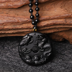 Black Obsidian Dragon Phoenix Pendant - Detailed relief carving of dragon and phoenix on obsidian disc with bead chain, Luck