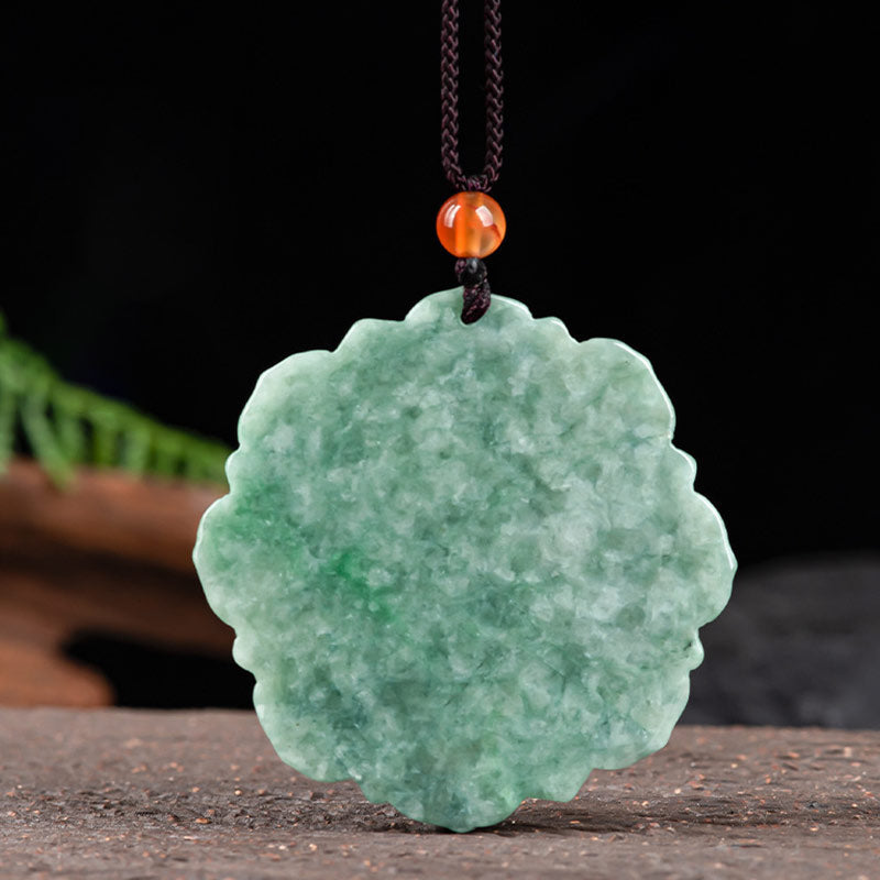 Jade Lotus Pendant Necklace – carved lotus pendant with amber bead amid fern fronds on speckled stone, Organic