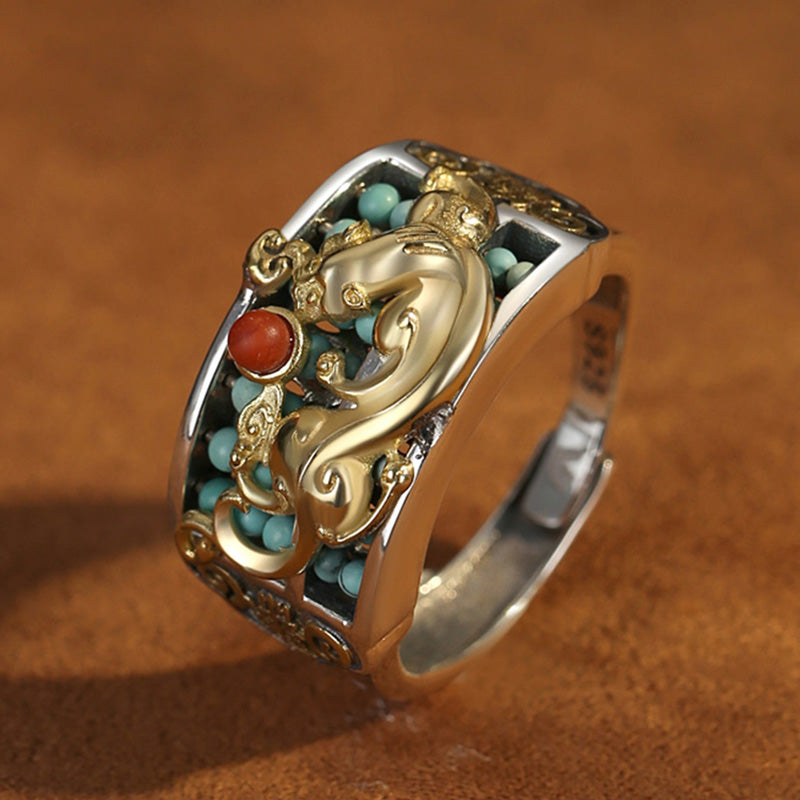 Silver PiXiu Ring – Close-up side gold PiXiu, turquoise beads, red agate on brown leather surface