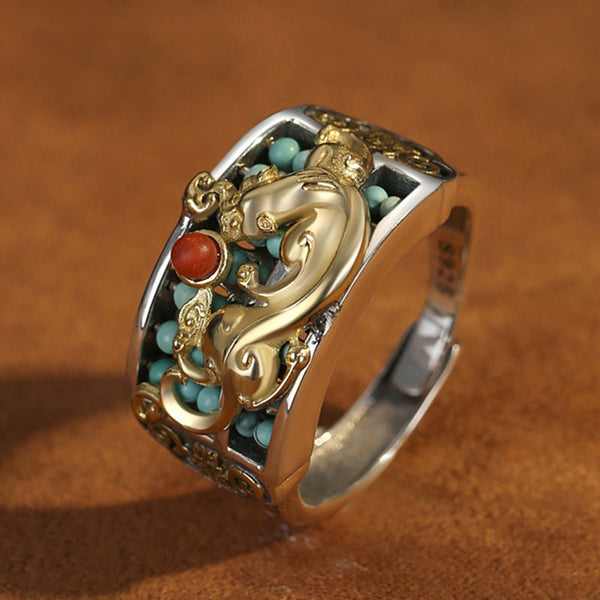 Silver PiXiu Ring – Close-up side gold PiXiu, turquoise beads, red agate on brown leather surface