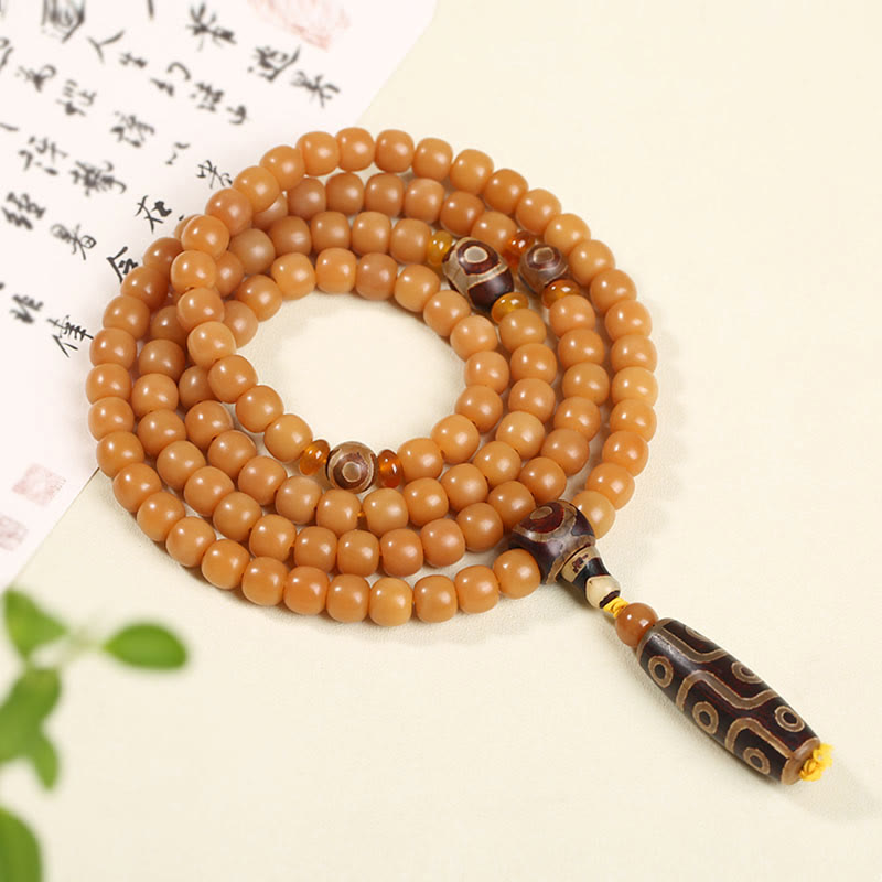 Bodhi Seed Lotus Dzi Bracelet - Amber dzi beads with nine-eye patterns coiled near calligraphy, dzi bead