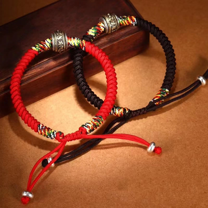 Tibetan Mantra Bracelet – Red and black pair with silver mantra beads on wooden display, couples bracelets