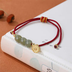 Hetian Jade Lotus Pod Braided Bracelet – red cord with jade beads on classic book, auspicious