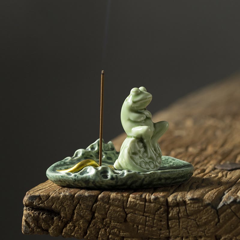 Ceramic Frog Incense Burner – Low angle on weathered wood, gold fish accent, Nature