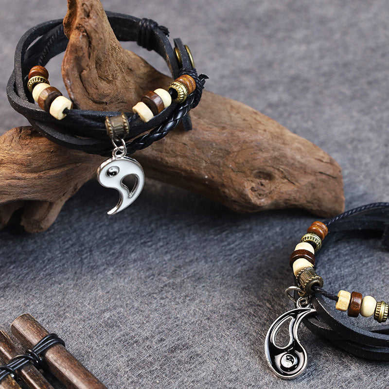 Copper Yin Yang Balance Bracelet - Leather bracelet on driftwood display with yin-yang pendant detail