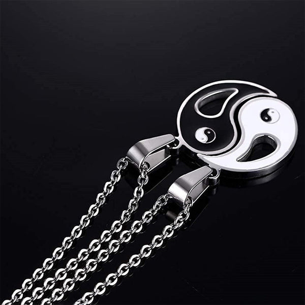 Yin Yang Pendant Couple Necklace Set - Split yin-yang necklace pendants with silver chains on glossy black surface, couple...