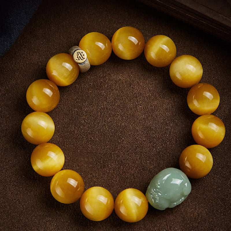 Zodiac Tiger Eye Jade Bracelet – Golden tiger eye beads with green jade PiXiu on brown fabric