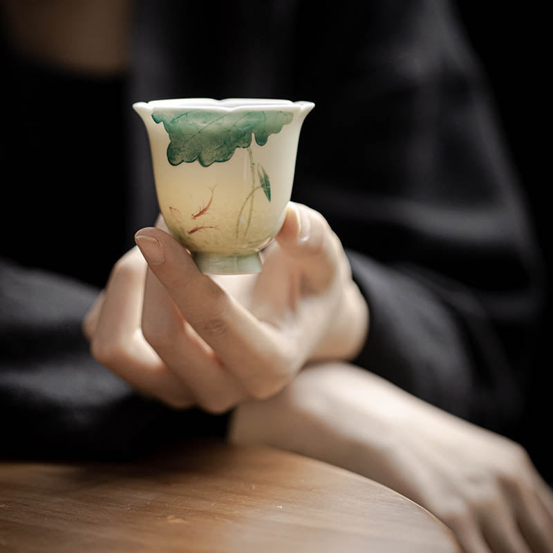 Koi Lotus Teacup – Held in hand showing 65ml capacity and shape