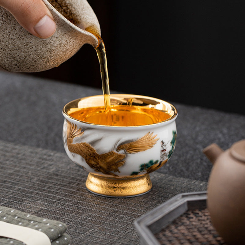 Golden Eagle Dragon Gilt Ceramic Teacup – golden eagle with pine tree, tea pouring action, gold-plated interior, ceremonial