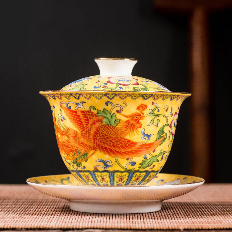 Dragon Phoenix Flower Gaiwan Tea Set – Yellow phoenix gaiwan on dark backdrop with woven mat, imperial porcelain