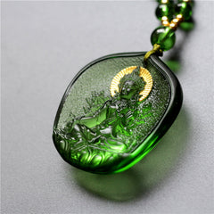 Green Tara Buddha Crystal Pendant – side angled view showing gold halo and carved depth, angled depth