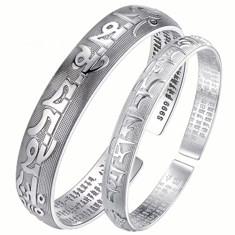 Two matching Tibetan Om Mani Padme Hum S999 fine silver prayer bangles showing both exterior mantra and interior micro-engraved text.