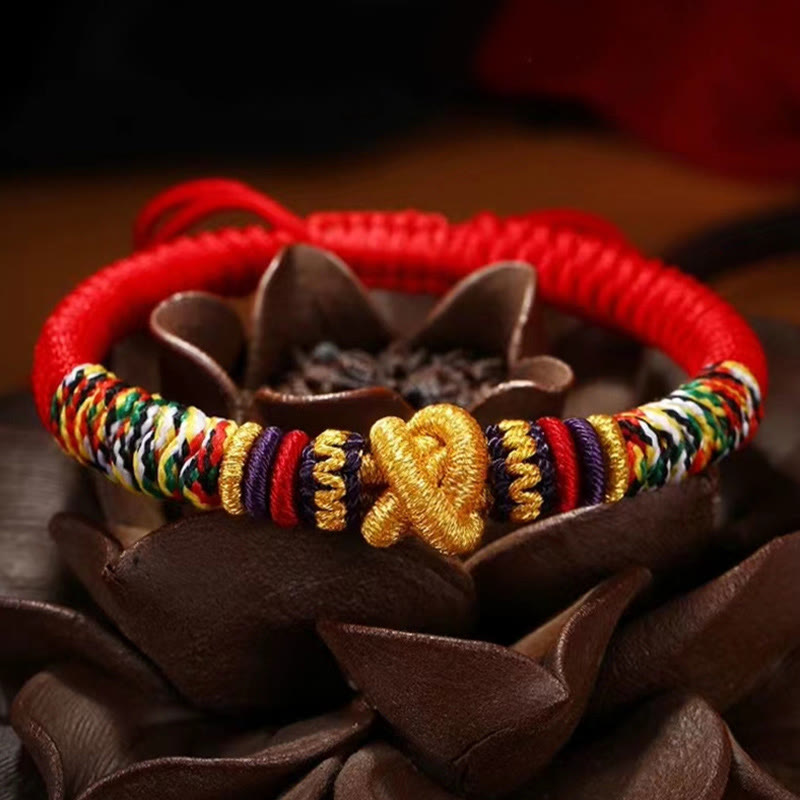 Tibetan Mantra Bracelet – Red cord with gold centerpiece on brown lotus stand, handcrafted jewelry