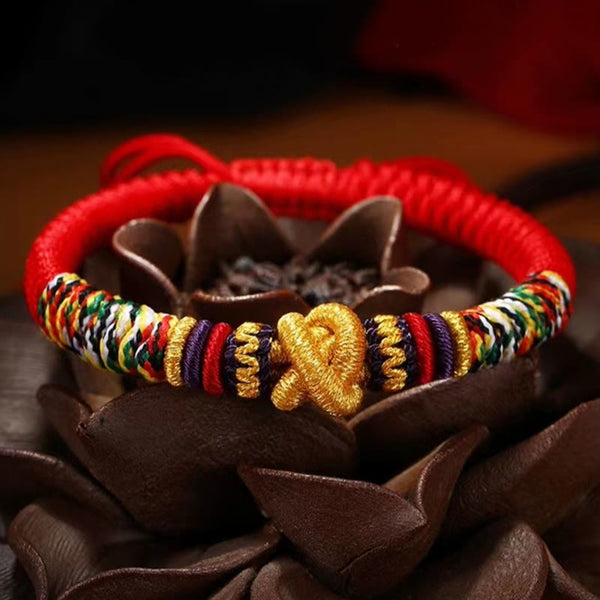 Tibetan Mantra Bracelet – Red cord with gold centerpiece on brown lotus stand, handcrafted jewelry