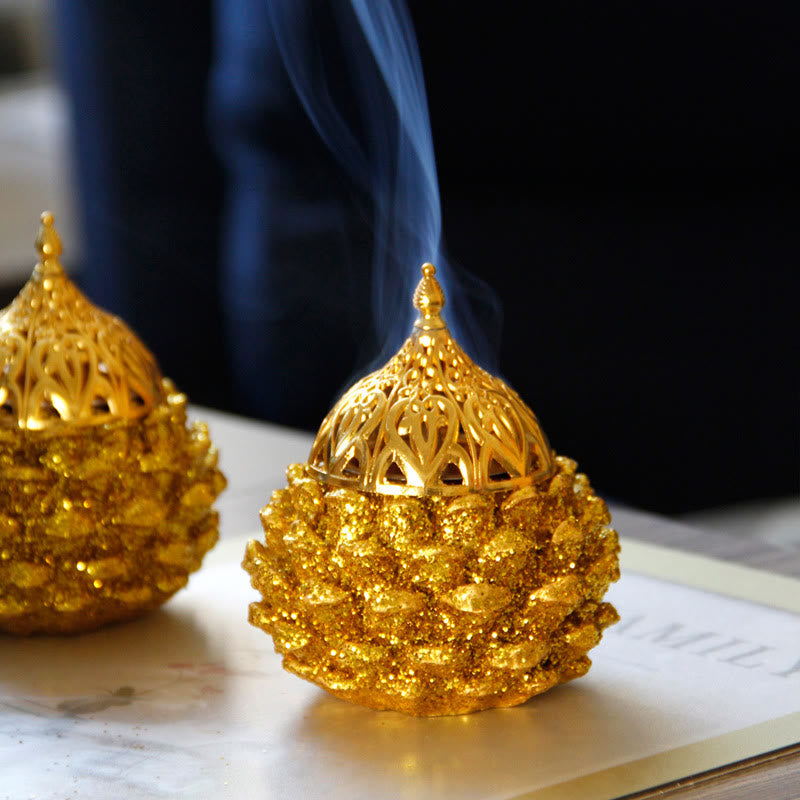 Gold Pine Cone Mini Incense Burner - Two golden units with blue smoke, dark bokeh, ritual decor Main image