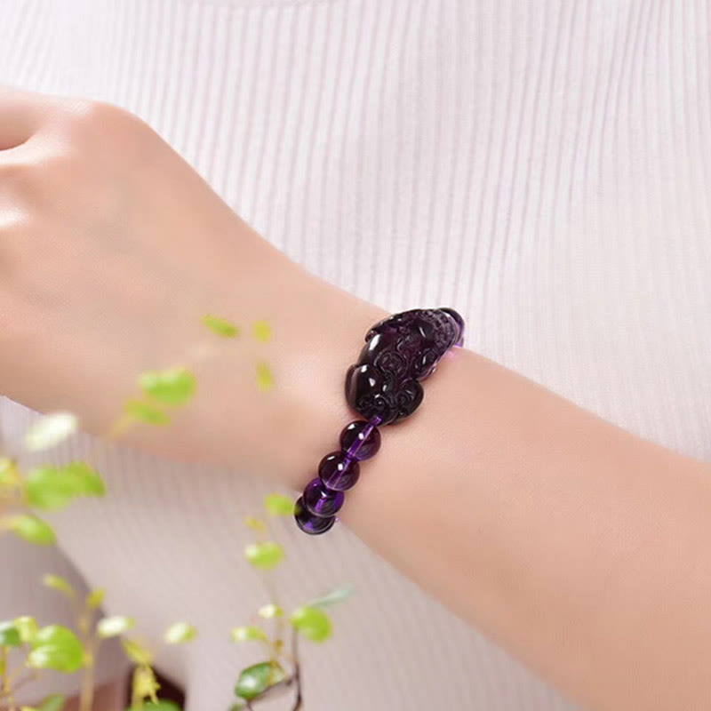 Amethyst PiXiu Fortune Bracelet – Worn on wrist with green leaves, amethyst PiXiu fortune jewelry
