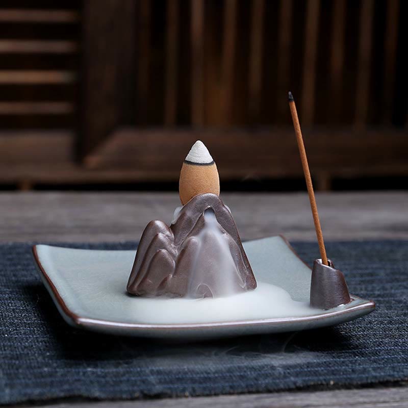 Lotus Ceramic Backflow Incense Burner - mountain backflow with cascading smoke on celadon tray, dual incense