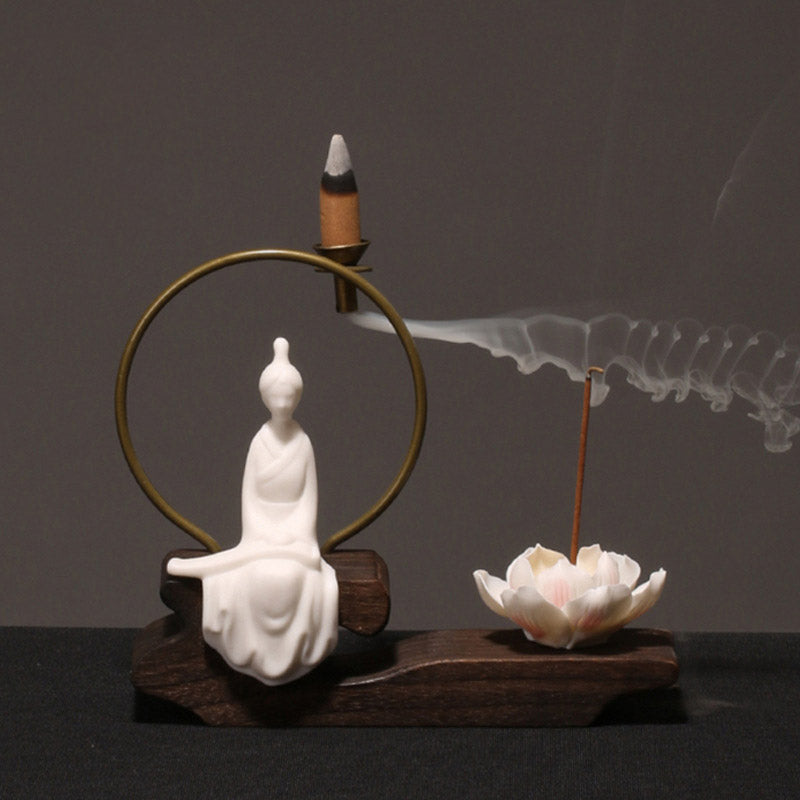 Ceramic Lotus Incense Burner – white bowing figure, smoke wisps, brass circle, wood base, zen