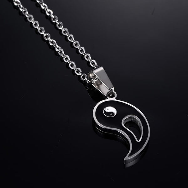 Yin Yang Pendant Couple Necklace Set - Black yin-yang pendant half with silver chain on dark reflective surface, couples j...