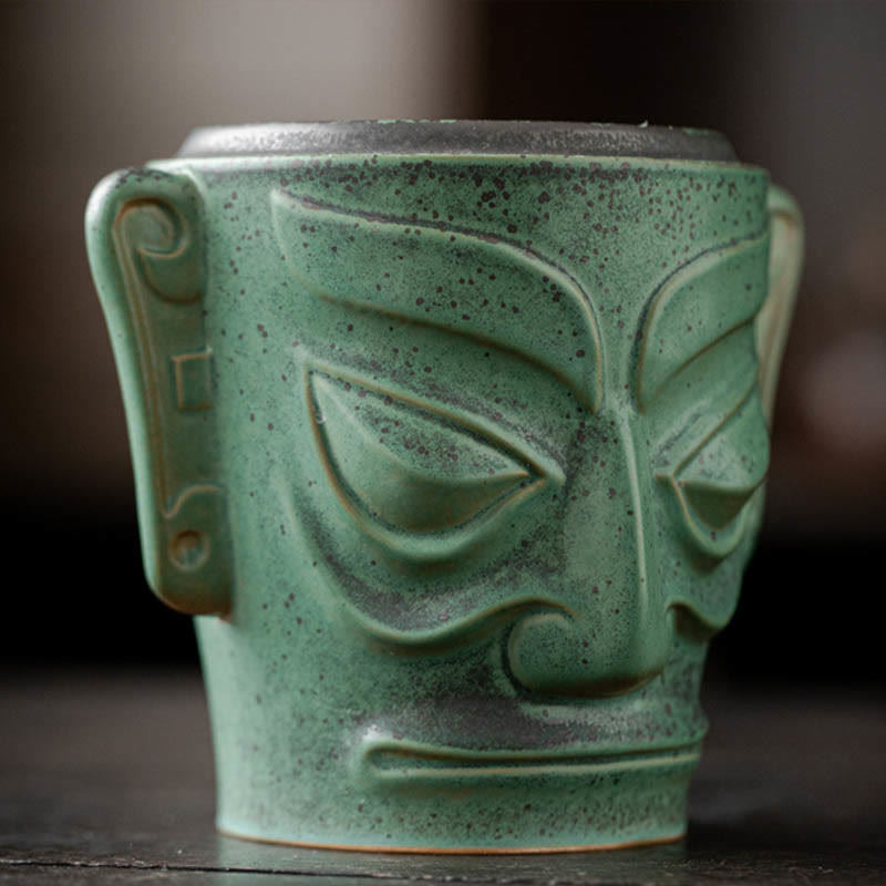 Sanxingdui Bronze Mask Incense Burner – Sculptural face detail with almond eyes and spiral ears, green patina