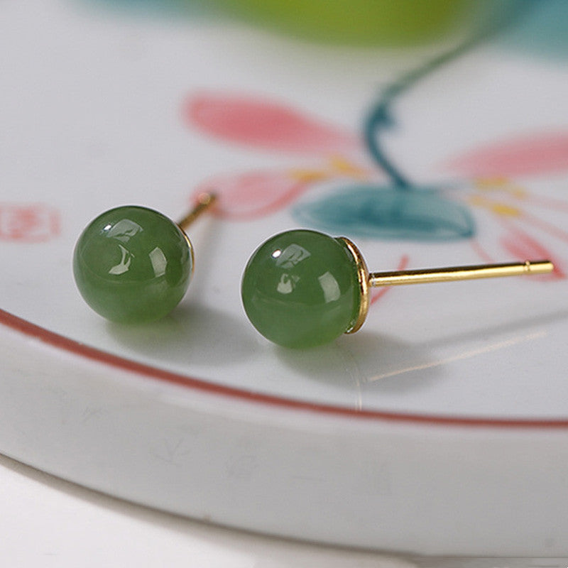 925 Silver Cyan Jade Healing Stud Earrings – olive green jade studs on pink floral ceramic dish, low side-angle with post detail