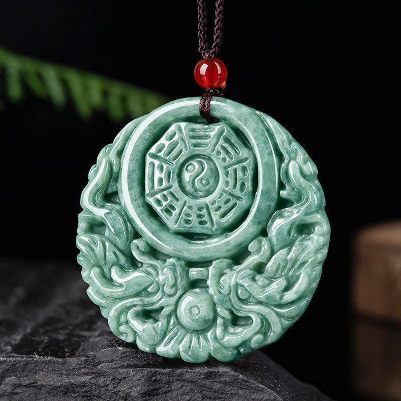 Dragon Jade Yin Yang Necklace – Green jade donut pendant on black cord worn on collarbone, dark gray textured background, lifestyle side shot