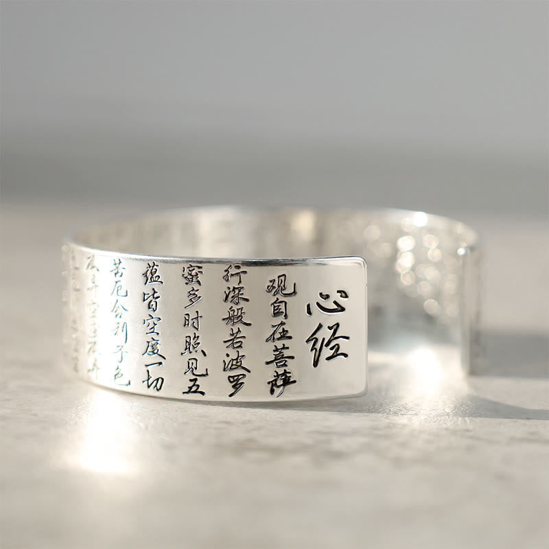 Tibetan Lotus White Copper Luck Bracelet - Silver cuff engraved with Heart Sutra text low angle, Sacred scripture