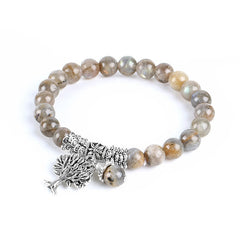 Tree of Life labradorite bracelet with gray beads showing blue-green iridescent flashes, ornate silver Tree of Life charm and floral bead caps.