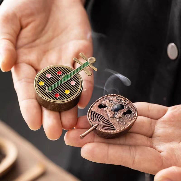 Copper Incense Burner Set – pipa and fan shaped brass burners held in hands, enamel flowers