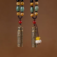 Ethnic Tibetan-style cylinder pendant necklaces with antique brass mantra tube, green jade, amber, and red agate beads on brown braided cord