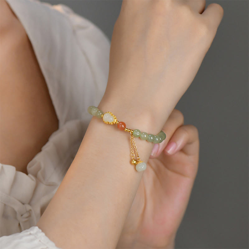 Sterling Silver Jade Gourd Lotus Bracelet on model wrist, shallow focus dreamy bokeh, lifestyle jewelry