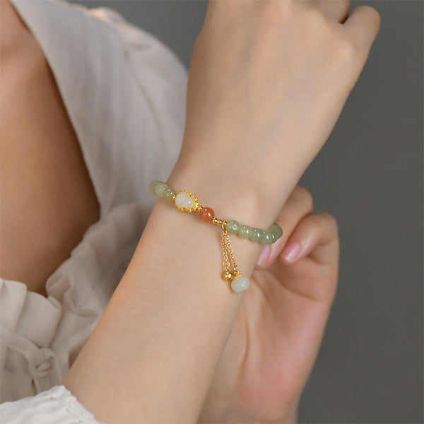 Sterling Silver Jade Gourd Lotus Bracelet on model wrist, shallow focus dreamy bokeh, lifestyle jewelry