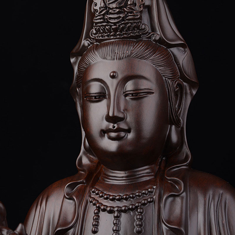 Ebony Avalokitesvara Lotus Decoration – Crown and serene face with chiaroscuro lighting, carved wood bodhisattva