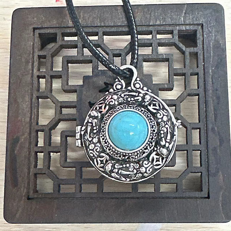 Tibetan Pi Xiu Necklace – Silver locket on carved black wood stand with leather cord