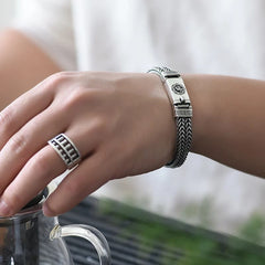 Om Mani Padme Hum Braid Bracelet – Worn on wrist with ring, lifestyle shot, men's jewelry