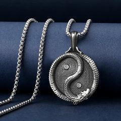 Yin Yang Dragon Pendant – Draped on navy stand revealing carved relief and chain, Mystical
