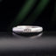 Lotus Enlightenment Ring - engraved lotus band on dark textured surface with green bokeh, silver