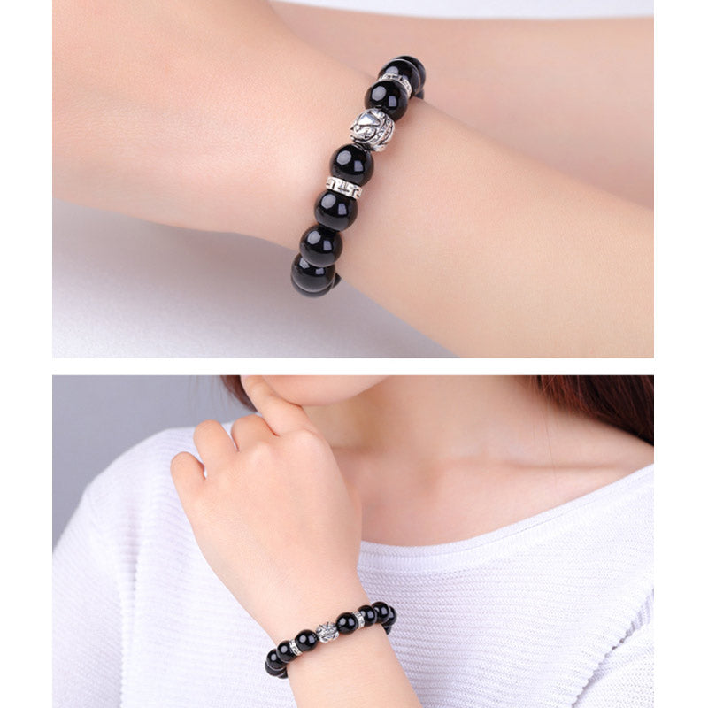 Rainbow Obsidian Bracelet – Woman wearing with white top, lifestyle product shot, blessing jewelry