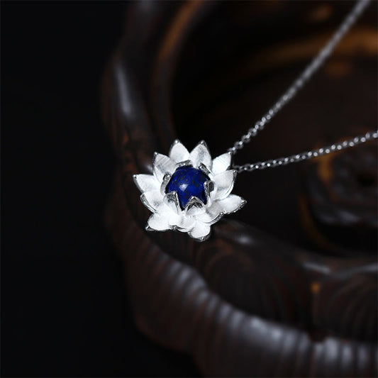 Lapis Lazuli Lotus Necklace - three-quarter view of textured silver lotus with royal blue stone, silver pendant