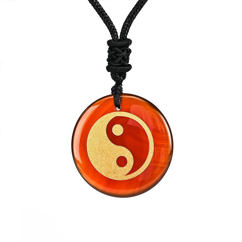 Yin Yang Crystal Necklace – Blue sodalite round pendant with gold yin-yang symbol, natural crystal marbling on black cord, we