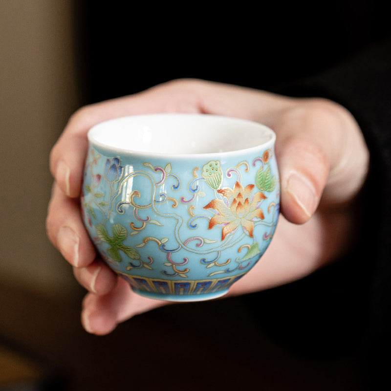 Lotus Pod Ceramic Tea Cup – sky blue lotus enamel cup held in both hands, gongfu tea