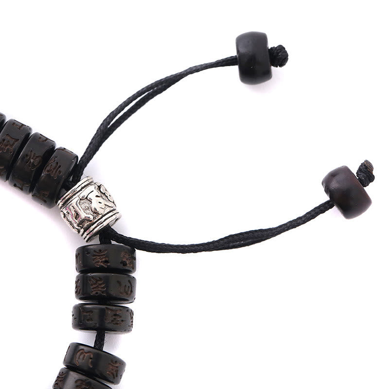 Coconut Shell Dorje Vajra Bracelet – Close-up of sliding knot closure with ornate silver accent bead and carved wooden bea...