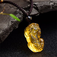 Citrine PiXiu Necklace Pendant – Golden PiXiu pendant on dark stone with green leaf, happiness jewelry