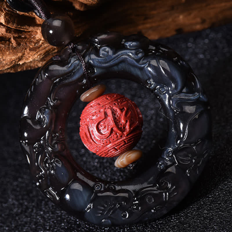 Rainbow Obsidian PiXiu Pendant – Close-up of rainbow obsidian ring with carved red cinnabar bead