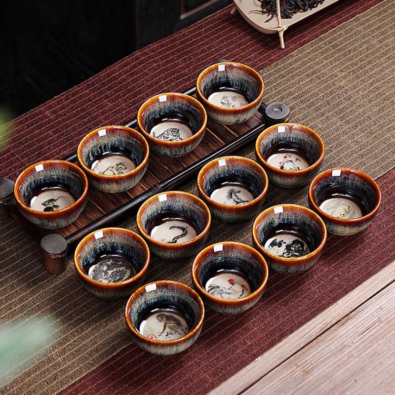 12 Zodiac Jian Zhan Teacup - classic hare fur stoneware profile, amber-to-silver gradient, unglazed terracotta foot