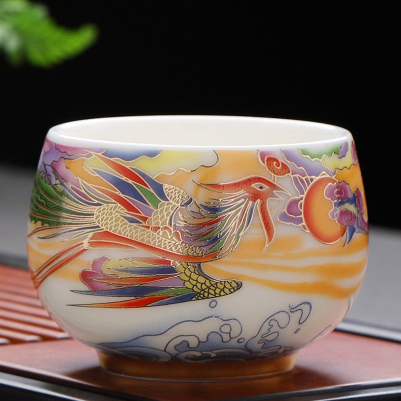 Dragon Phoenix Ceramic Teacup - Multicolored phoenix with gold accents on dark backdrop, elegant